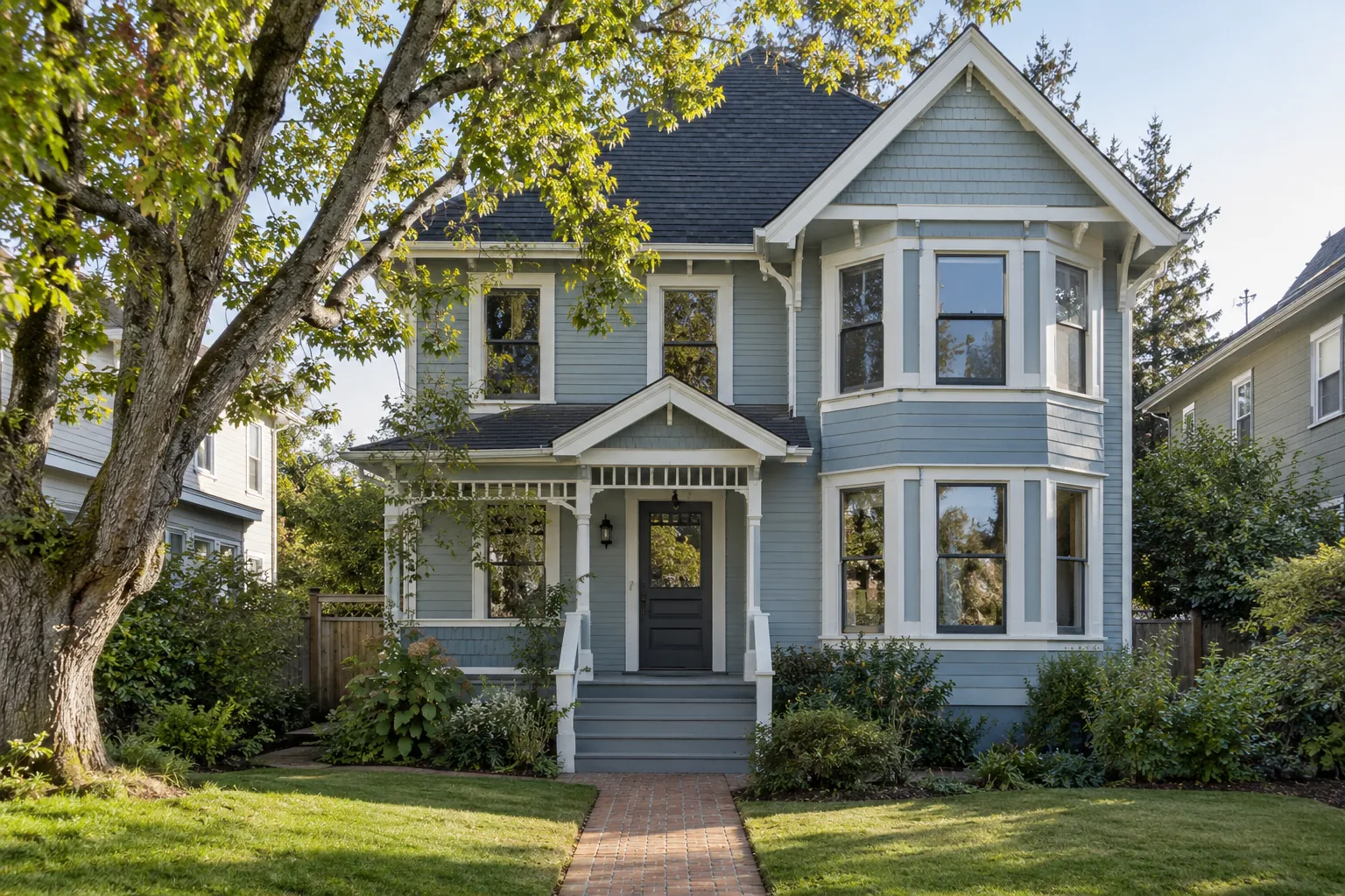 Blue two-story house with white trim and a brick front walkway