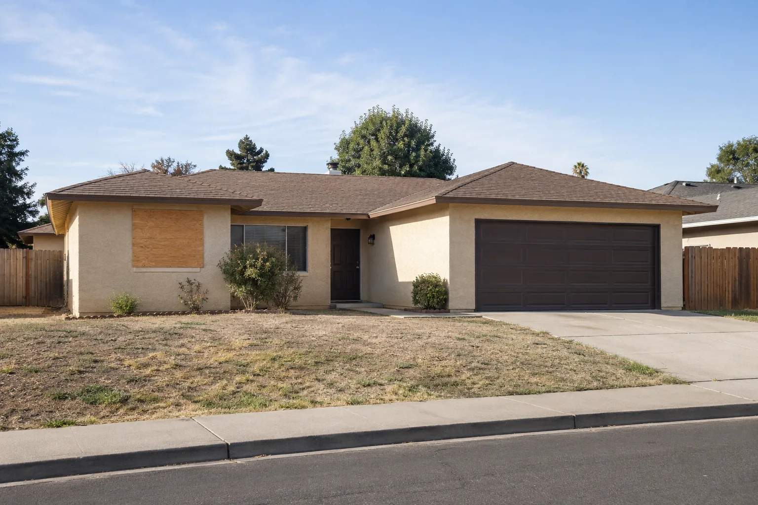 Tan ranch house with an attached garage and a secured window