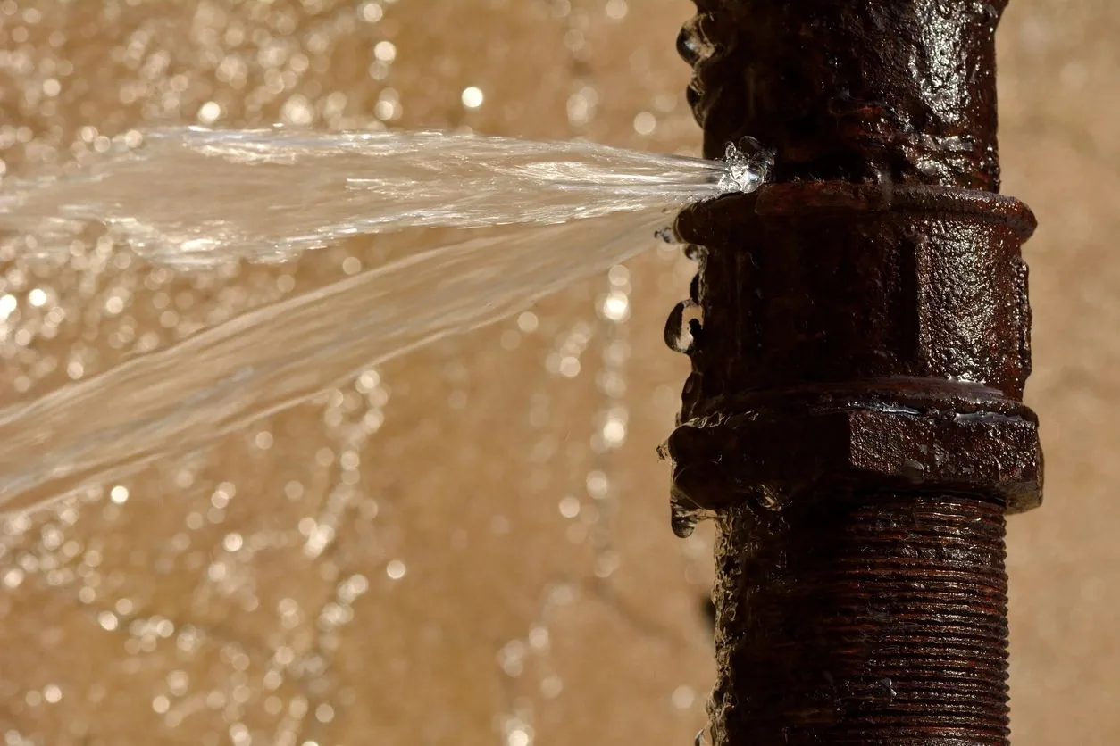 Water spraying from a damaged pipe