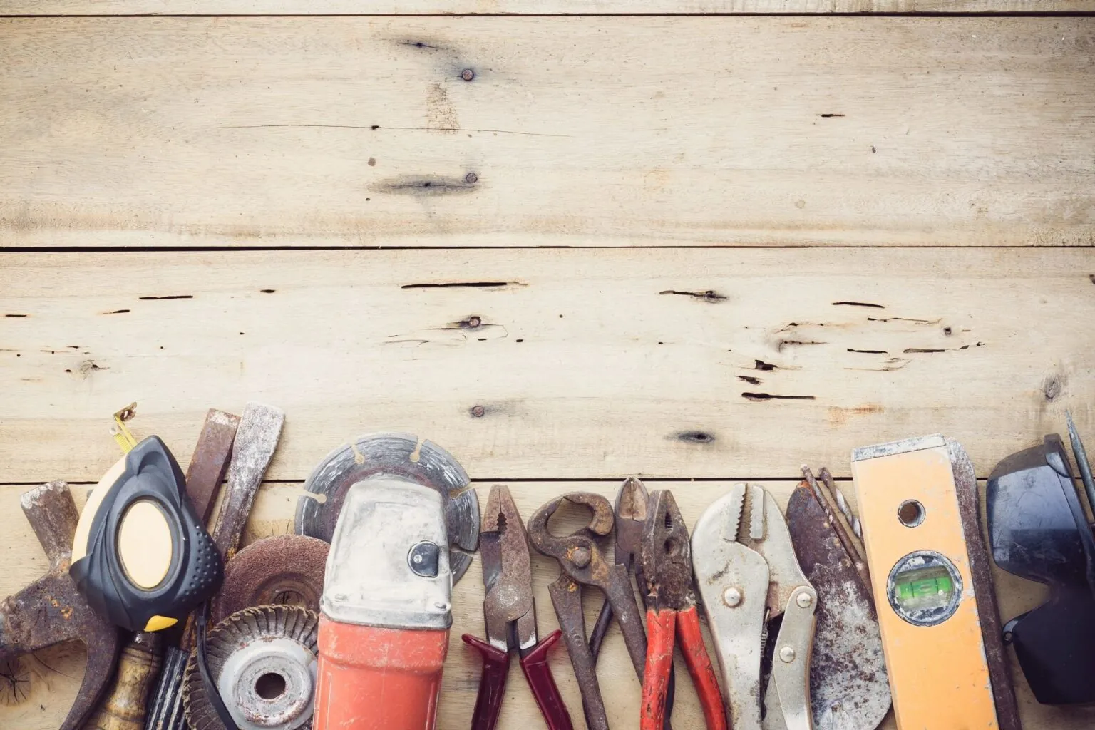 Hand tools arranged on a wooden workbench