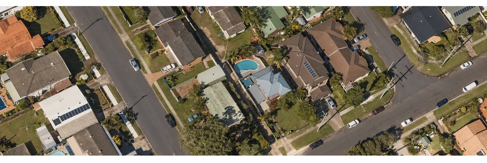 Aerial view of a residential neighborhood with homes, trees and streets