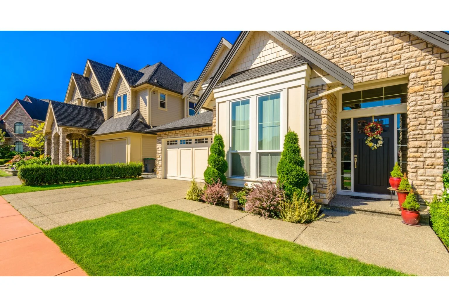 Stone-front homes with entryways and driveways